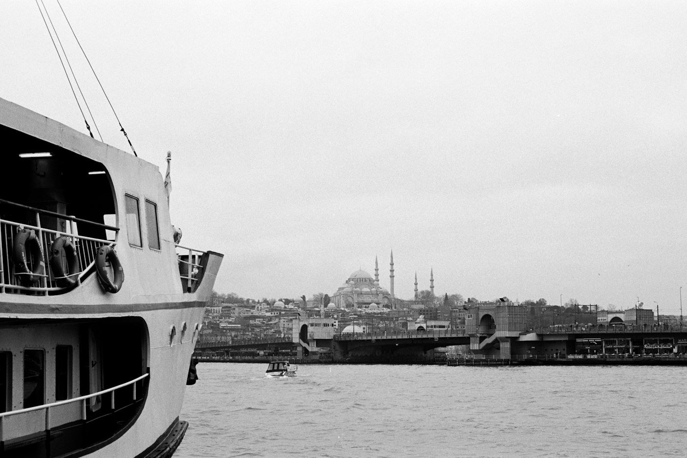 İstanbul sahilinde vapur, köprü ve cami silueti